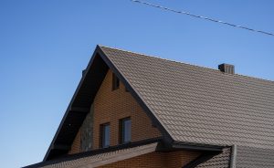 A Two story home with a brown metal roofing system.