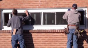 Picture of two men installing a window.