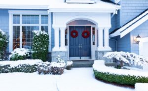 Large residential property with beautiful front doors with decorative wreaths.